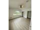 Bright bedroom featuring a large arched window, ceiling fan, and two closets, perfect for relaxation and storage at 5999 Lake Pointe Dr # 602, Orlando, FL 32822