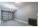 View of an empty two car garage with a gray floor and white walls, ready for customization and organization at 5999 Lake Pointe Dr # 602, Orlando, FL 32822