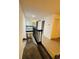 Bright hallway features wood-look floors, access to stairs, and natural light from the windows at 5999 Lake Pointe Dr # 602, Orlando, FL 32822
