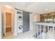 Hallway showcasing convenient laundry closet with sliding barn door, complemented by a nearby bathroom at 5999 Lake Pointe Dr # 602, Orlando, FL 32822