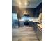 Modern kitchen with stainless steel appliances, custom cabinets, and stylish wood-look flooring at 5999 Lake Pointe Dr # 602, Orlando, FL 32822