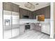 Stylish kitchen featuring stainless steel appliances, gray cabinetry, and modern fixtures at 5999 Lake Pointe Dr # 602, Orlando, FL 32822