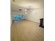 Spacious living room featuring neutral paint, light hardwood floors, and ample natural light from sliding glass doors at 5999 Lake Pointe Dr # 602, Orlando, FL 32822