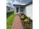 Inviting front entrance with a brick pathway and charming landscaping leading to the front door at 6028 Bimini Ave, Haines City, FL 33844