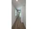 Bright hallway featuring modern flooring and neutral walls, leading to the rest of the home's living spaces at 6028 Bimini Ave, Haines City, FL 33844