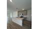 Bright kitchen with an island, stainless steel appliances, and gray cabinets at 6028 Bimini Ave, Haines City, FL 33844