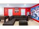 Vibrant game room features an L-shaped couch, foosball table, arcade game, and Marvel-themed decor at 7352 Oakmoss Loop, Davenport, FL 33837