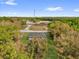Aerial view showcases a home nestled in a lush landscape, providing a sense of privacy and seclusion at 75 Guava Ter, Ocklawaha, FL 32179