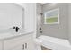 Bright bathroom featuring a single vanity, quartz counters, black fixtures, and bathtub shower combination at 75 Guava Ter, Ocklawaha, FL 32179