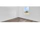 Empty bedroom with wood-look floors and a window with backyard views at 75 Guava Ter, Ocklawaha, FL 32179
