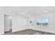 Bright bedroom with a view to the yard through the window; wood floors and white walls at 75 Guava Ter, Ocklawaha, FL 32179