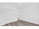 An empty bedroom with a closet and neutral paint is staged with wood-look flooring at 75 Guava Ter, Ocklawaha, FL 32179