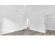 Empty bedroom with wood-look flooring, base molding, and access to walk-in closet at 75 Guava Ter, Ocklawaha, FL 32179