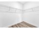 Walk-in closet featuring ample shelving and wood-look floors providing storage solutions at 75 Guava Ter, Ocklawaha, FL 32179