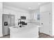 The kitchen features stainless appliances, white cabinetry, and quartz countertops at 75 Guava Ter, Ocklawaha, FL 32179