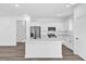 Bright kitchen with stainless steel appliances, white cabinetry, and a spacious center island with quartz countertops at 75 Guava Ter, Ocklawaha, FL 32179