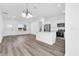Kitchen features stainless steel appliances, large island, and open concept living area with modern luxury vinyl plank flooring at 75 Guava Ter, Ocklawaha, FL 32179