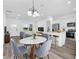 Open concept living space with kitchen island and stainless steel appliances, dining area, and comfortable living room at 75 Guava Ter, Ocklawaha, FL 32179