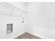 The empty laundry room has connections for appliances and wire rack shelving at 75 Guava Ter, Ocklawaha, FL 32179