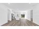 Bright and open living space with modern wood floors and a view of the kitchen and backyard at 75 Guava Ter, Ocklawaha, FL 32179