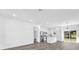 Bright and open living space with modern wood floors and a view of the kitchen and backyard at 75 Guava Ter, Ocklawaha, FL 32179