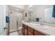 Neutral bathroom showcasing double sinks, a glass shower, and ample counter space at 7660 Ripplepointe Way, Windermere, FL 34786