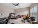 Carpeted bedroom with a ceiling fan, natural light from the window, and neutral walls at 7660 Ripplepointe Way, Windermere, FL 34786