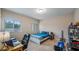 Bright bedroom with two windows, a ceiling fan, a desk, and neutral walls at 7660 Ripplepointe Way, Windermere, FL 34786