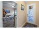 Bright entryway boasts a decorative glass door and a glimpse into the bedroom with modern flooring at 7660 Ripplepointe Way, Windermere, FL 34786