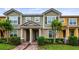 Charming townhome featuring a well-maintained lawn, brick walkway and neutral color scheme at 7660 Ripplepointe Way, Windermere, FL 34786