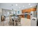Open kitchen and dining area featuring stainless steel appliances, tile floors, and ample cabinet space at 7660 Ripplepointe Way, Windermere, FL 34786