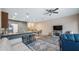 Open living space with plank flooring, a ceiling fan, and comfortable seating at 7660 Ripplepointe Way, Windermere, FL 34786