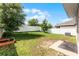Large backyard is fenced in and features a lush lawn perfect for outdoor activities at 812 Marcel Loop, Davenport, FL 33837