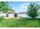 This backyard features a well-maintained lawn and a white privacy fence, creating a serene outdoor space at 812 Marcel Loop, Davenport, FL 33837