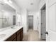 Bathroom with dual sinks, tile floors, a walk-in shower, and a walk-in closet at 812 Marcel Loop, Davenport, FL 33837