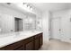 Bathroom features double sinks with quartz countertops, a large mirror, and a shower at 812 Marcel Loop, Davenport, FL 33837
