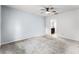 Bedroom features carpet flooring, a ceiling fan, and an en-suite bathroom at 812 Marcel Loop, Davenport, FL 33837