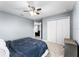 Cozy bedroom with carpet flooring features a ceiling fan, closet and neutral paint at 812 Marcel Loop, Davenport, FL 33837