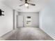 Bedroom features carpet flooring, a ceiling fan, and a view of the window at 812 Marcel Loop, Davenport, FL 33837