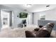 Relaxing bonus room with a TV, neutral carpet, and easy access to the bathroom at 812 Marcel Loop, Davenport, FL 33837
