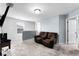 Inviting bonus room with a comfortable leather reclining sofa and neutral carpet at 812 Marcel Loop, Davenport, FL 33837