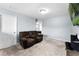 Cozy bonus room with a comfortable sofa, neutral carpet, and entertainment area at 812 Marcel Loop, Davenport, FL 33837