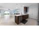 Bright, open kitchen with white countertops, dark wood cabinets and stainless steel appliances at 812 Marcel Loop, Davenport, FL 33837