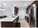 Modern kitchen with stainless steel appliances, white countertops, and dark wood cabinets at 812 Marcel Loop, Davenport, FL 33837