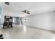 Open-concept living space boasts tile floors, an adjacent dining area, and staircase at 812 Marcel Loop, Davenport, FL 33837