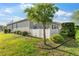 Landscaped backyard with green grass, a tree, and a white fence for added privacy at 8205 Sw 78Th Terrace Rd, Ocala, FL 34476