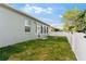 Spacious backyard with lush grass, a privacy fence, and access to the home's sunroom at 8205 Sw 78Th Terrace Rd, Ocala, FL 34476
