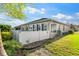 Well-maintained backyard with a white fence, lawn, and home's exterior at 8205 Sw 78Th Terrace Rd, Ocala, FL 34476
