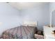 Cozy bedroom with light blue walls, a queen-size bed, and white furnishings at 8205 Sw 78Th Terrace Rd, Ocala, FL 34476