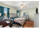 Comfortable main bedroom featuring a ceiling fan and wood-look floors at 8205 Sw 78Th Terrace Rd, Ocala, FL 34476